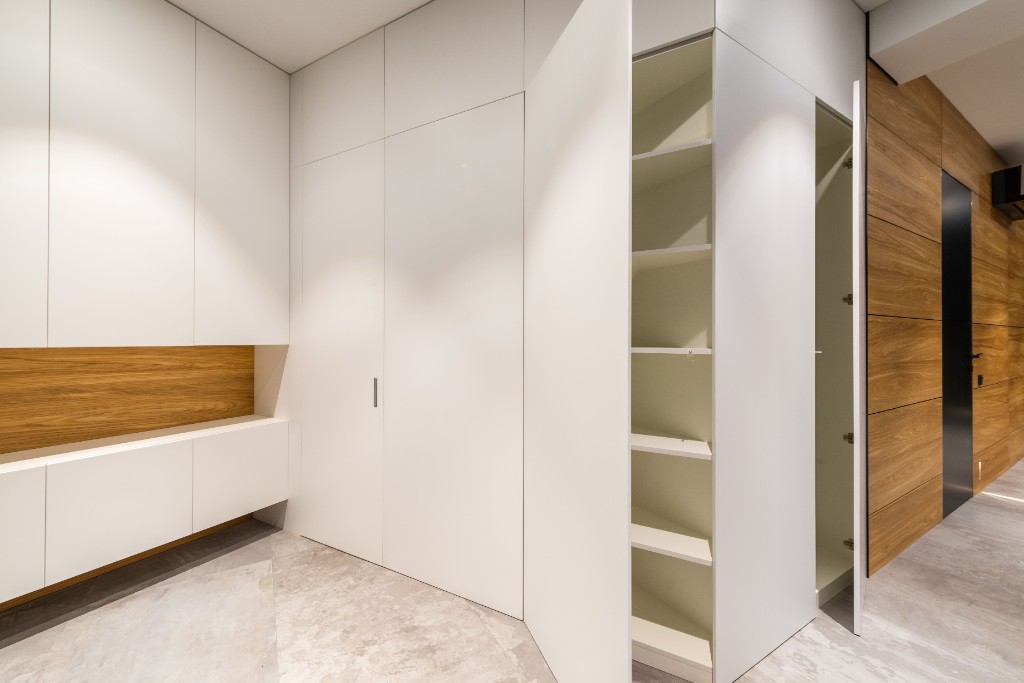 Built-in white cabinetry and wood panelling